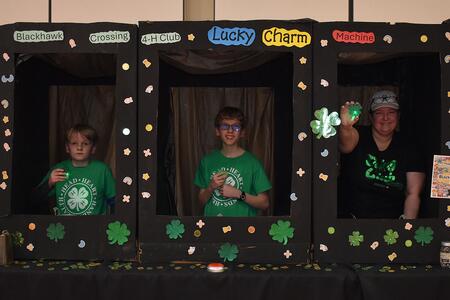 Three male youth with 4-H clovers