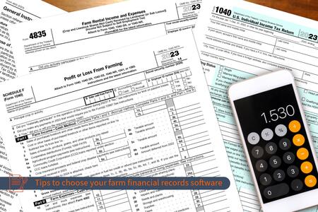 farm record tax forms and a cell phone calculator