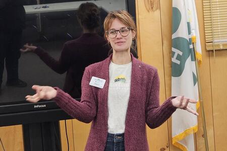 a lady presenting in front of room