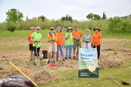 Group of people setting up a pollinator garden 
