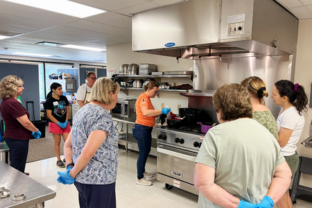 Educator demonstrating jam making to an audience