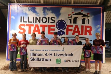 Winners pose with a banner.