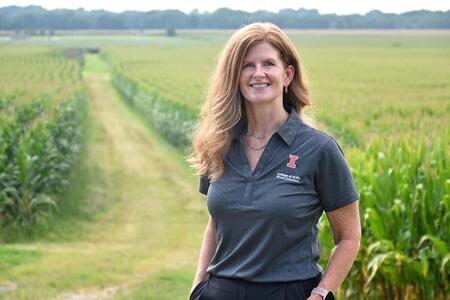 Tara Heath standing in front of a corn field