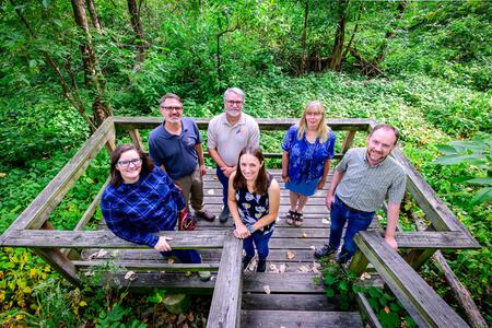 a group of people stand in a wetland