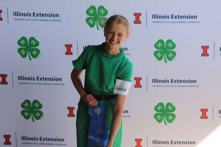 Maddy Canada poses with blue ribbon.