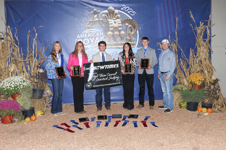 Team members pose with banners and ribbons.