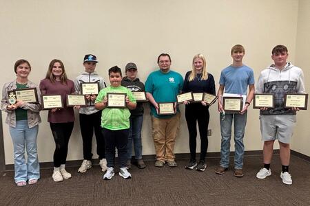 group of 4-H members holding plaques