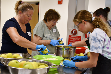 Class participants peeling and cutting apples