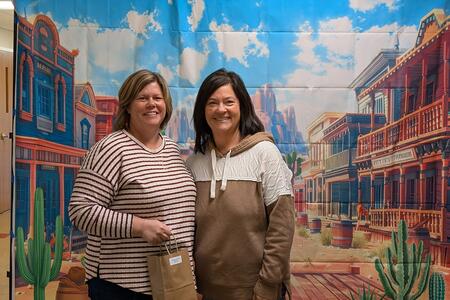 Two women standing and smiling