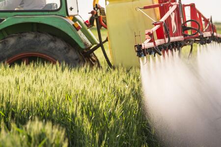 close-up of a tractor spraying a field