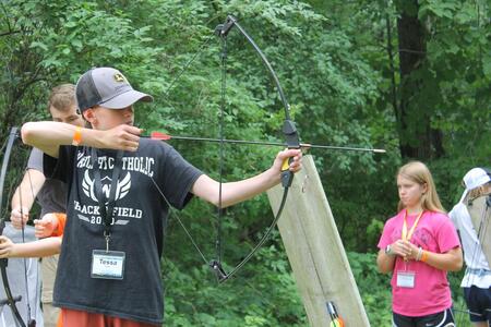 youth practicing shooting sports