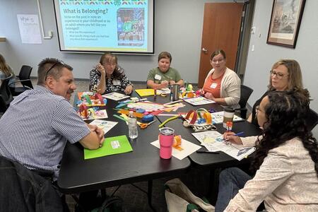 a table of 4-H leaders and club officers talking