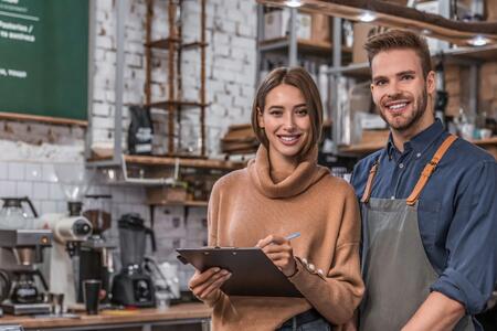 stock photo of a man and woman working in a coffee bar