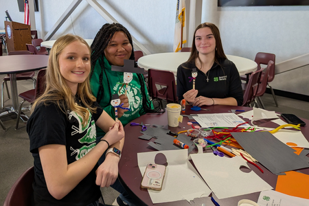 4-H members make crafts during an activity.