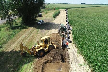 A tile contractor using large equipment to install a large tile main. (Photo by Kevin Brooks)