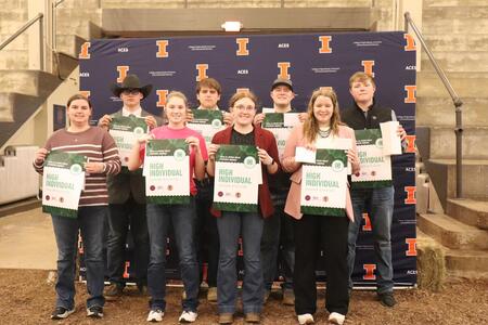 Winning youth pose with banners.