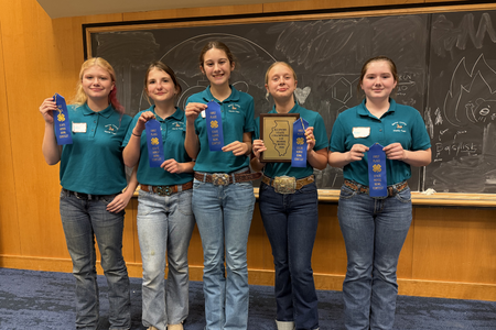 Youth pose with blue ribbons.
