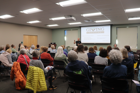 A large lecture room filled with people listening to a gardening presentation.