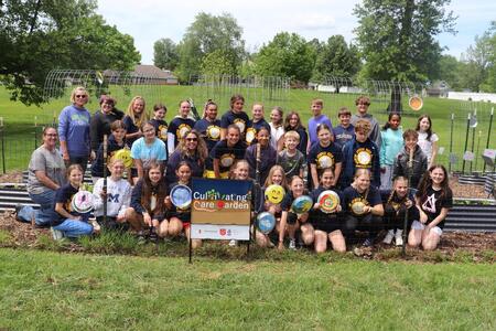 A large group of kids and adults who helped prepare the cultivating care garden.