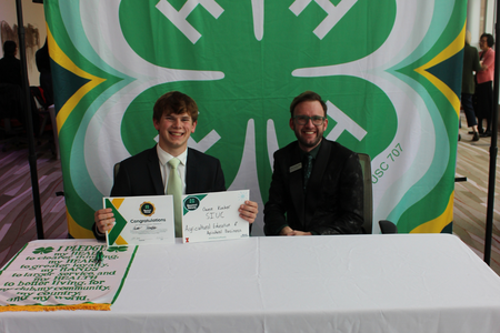 Recipient holds a sign outlining his plan to go to SIUC in ag studies. 