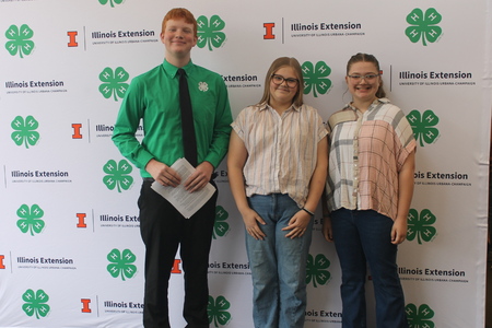 Youth participants gather in front of a backdrop.