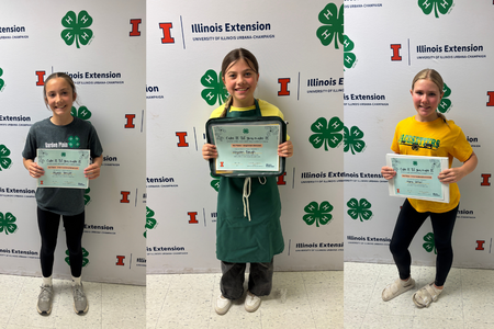 Three of the winners pose with their certificates.