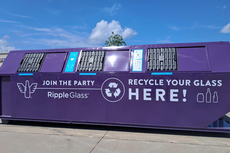 A purple glass recycling dumpster.