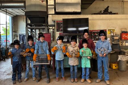 Saline County SPIN Club participants stand in the SIC welding shop.