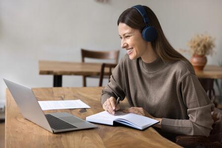 smiling woman looking at computer during an online session