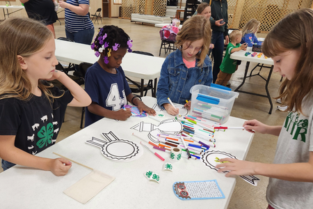 A group of young Cloverbuds work on art projects as part of the Cloverbud Showcase.