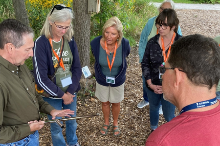 People observe a hands-on soil sampling demonstration during an Illinois Extension training.