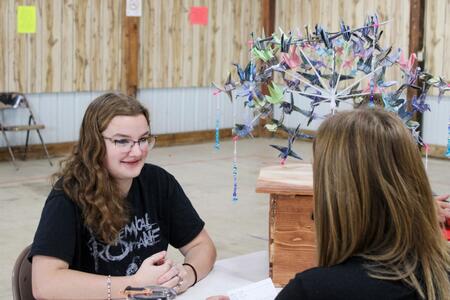 Daphne Heeley being judged for their creative 3-D project. 
