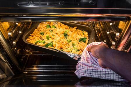 casserole in pan being pulled out of an oven