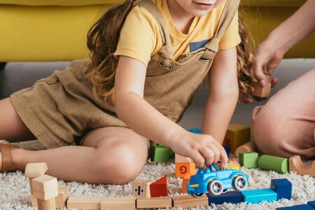 a child sitting on the floor playing with toys