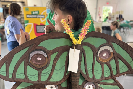 teenager modeling human-sized paper wings