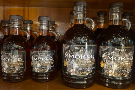 jugs of maple syrup on a shelf