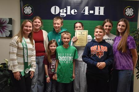 Group of youth standing with certificate.
