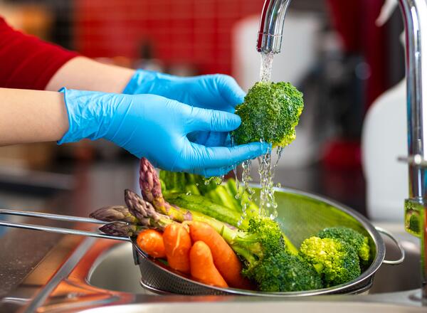 washing vegetables in sink