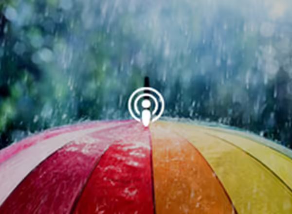 Colorful umbrella with rain coming down