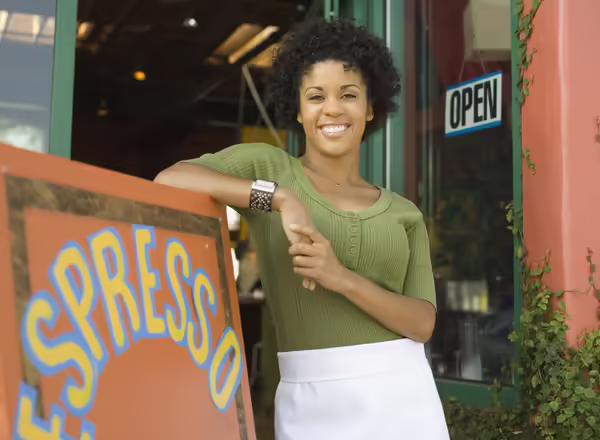Woman in front of her coffee shop