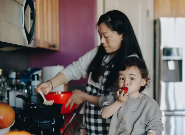young child and mother cooking