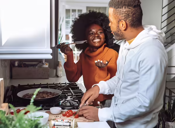 happy couple cooking