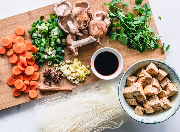 carrots green and mushrooms on cutting board