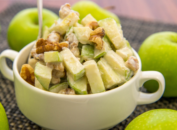 Bowl of apple walnut salad with mayonnaise-based dressing