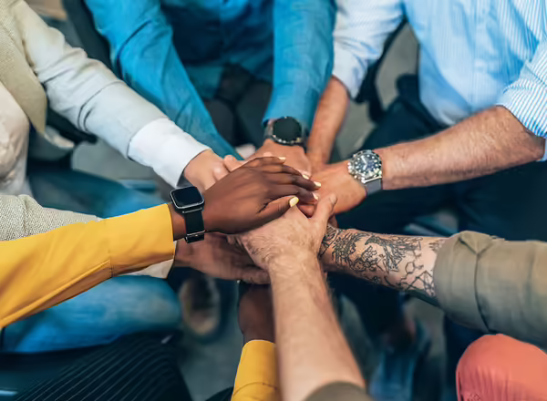 arms and hands of people with diverse skin tones and of diverse ages
