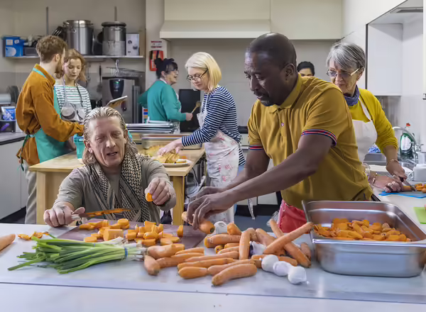 diverse volunteers working in a soup kitchen