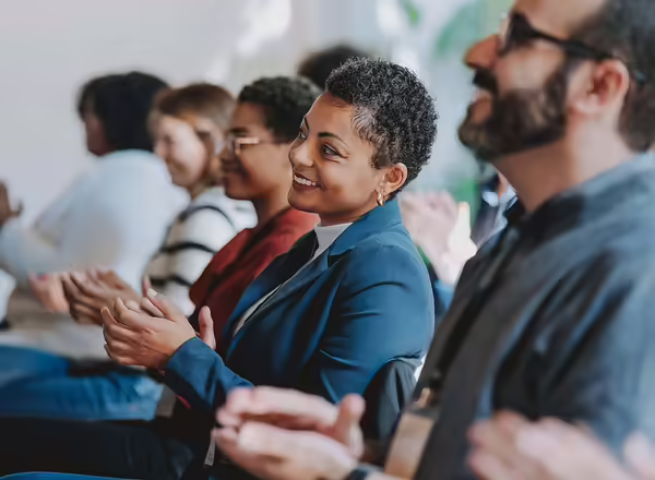 people smiling during business meeting