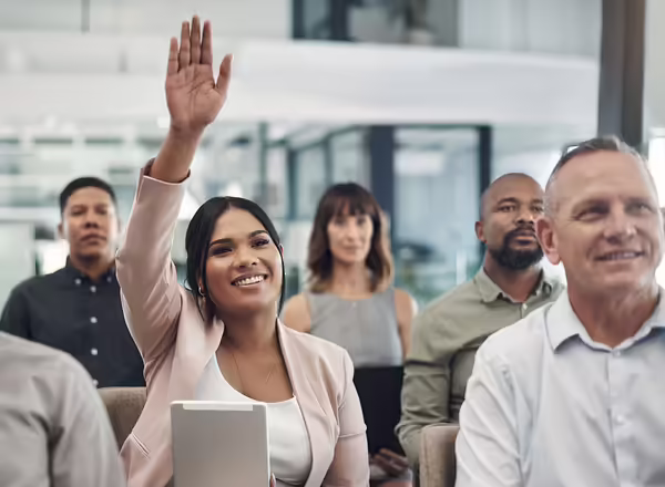 Shot of a young businesswoman raising her hand during a presentation in an office