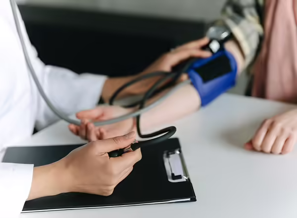 doctor taking a person's blood pressure