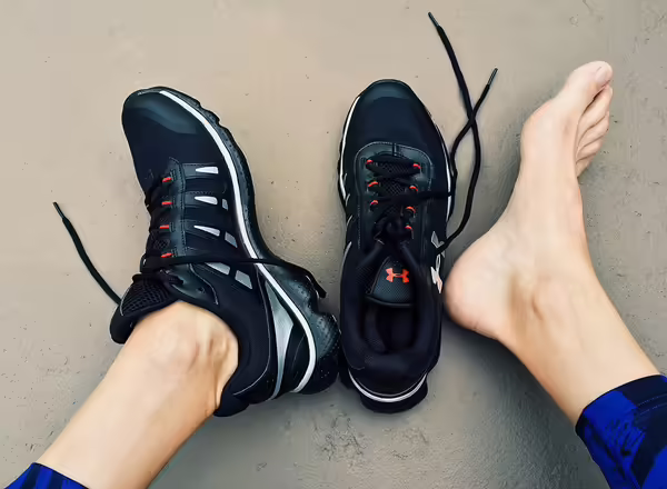 person taking off one shoe to show a barefoot